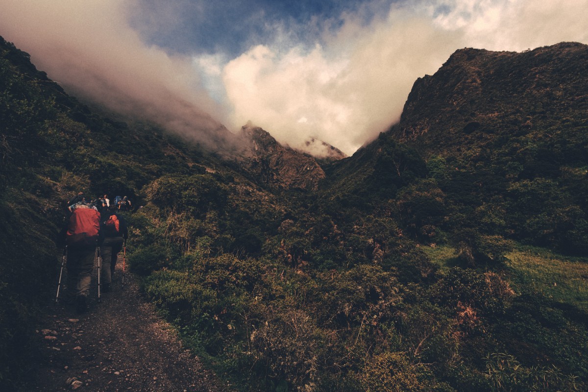 mountain hikers trail clouds