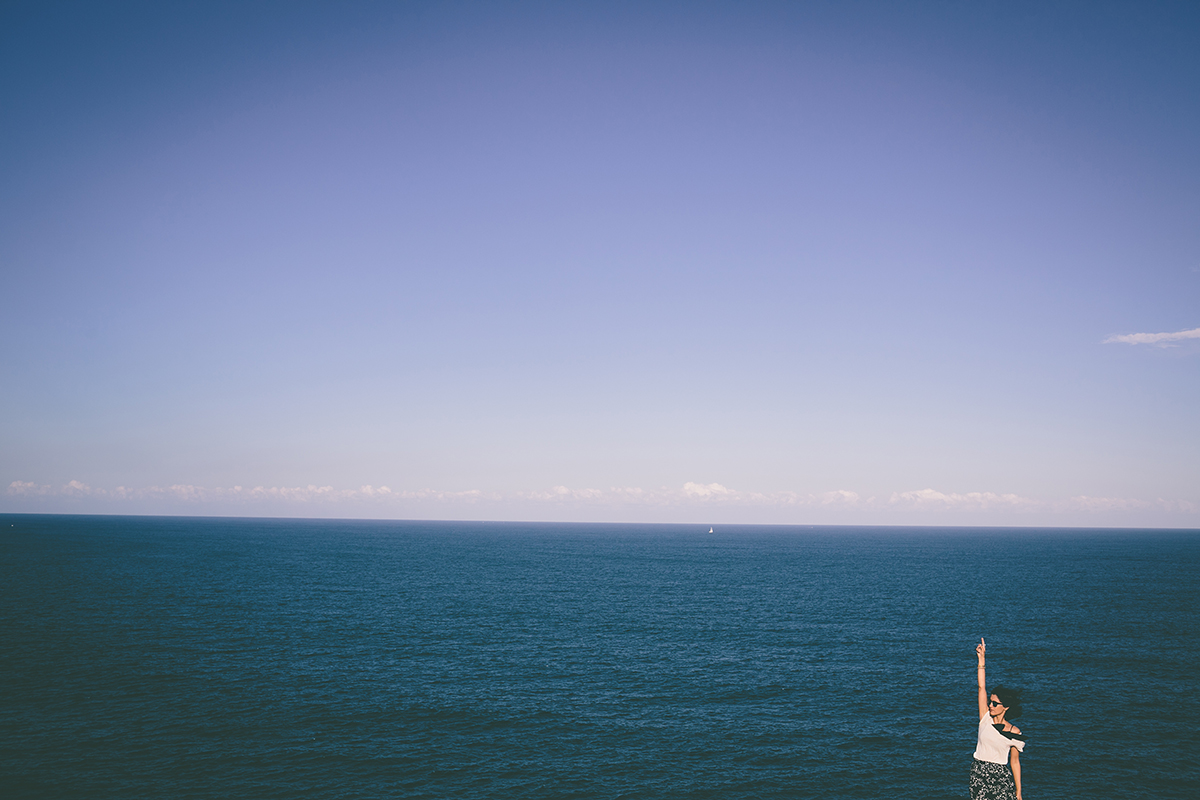 Woman pointing at the sky ocean